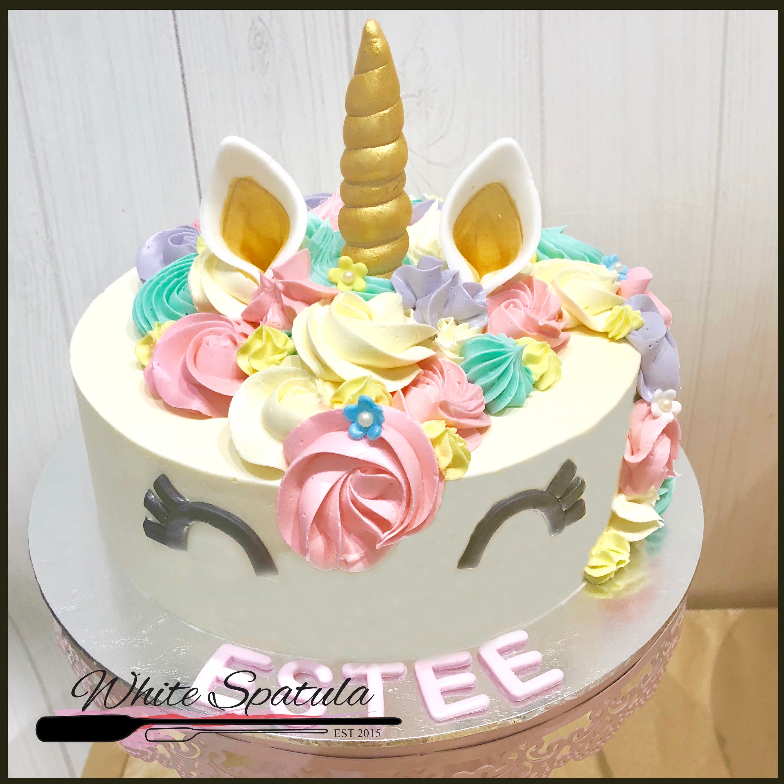 Fondant covered cake with Rainbow Unicorn decor - Buns Bakery